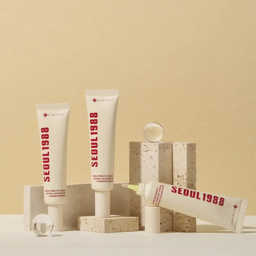 Three K-Secret skincare cream tubes with red lettering displayed in a collection